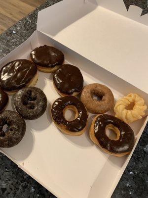 Normal sized Boston cream, anemic chocolate, mini blueberry, and mini cruller.