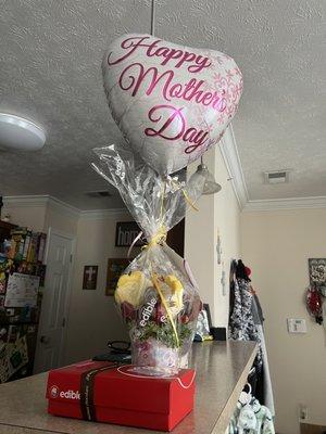 A fruit basket and a box of cookies and muffins