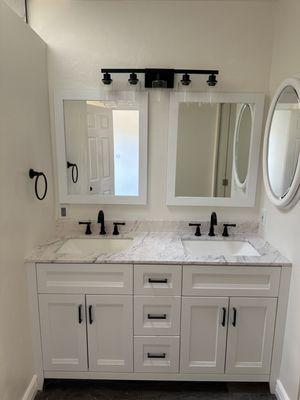 Bathroom refresh: New vanity, mirrors, light and faucet fixtures installed.