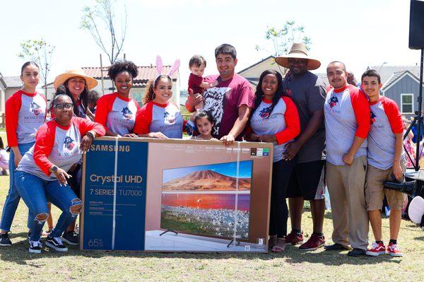 The squad at their Annual Easter Egg Hunt giving away a free TV to a family.