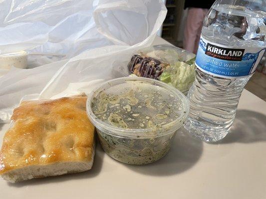 Tortellini pesto not even full. Water bottle for reference. $14 meal not worth it