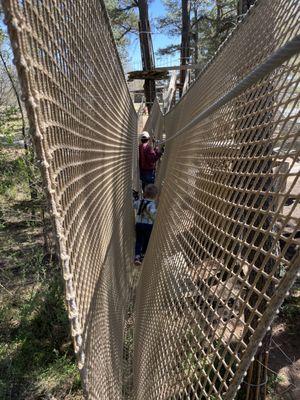 3.5 year old son and husband climbing the netting