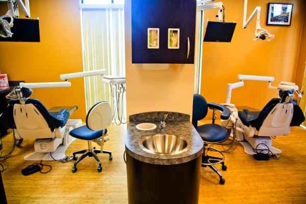 Clean, modern, and spacious treatment rooms with natural lighting, and individual TVs for patient comfort
