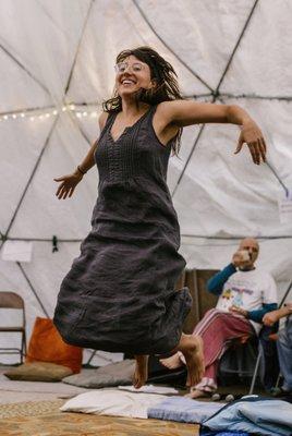 A woman jumps for joy.