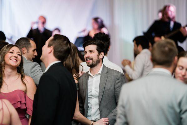 Band in the background of people dancing at wedding