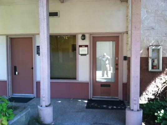 First Unit to the right at the bottom of the stairs.  Look for white doorbell button on right side of door.