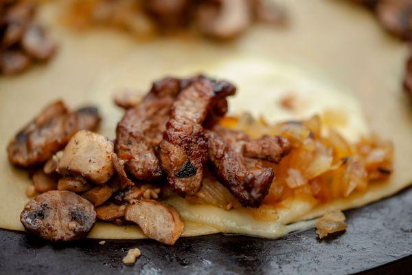 Steak Crepe Marinated tri-tip steak, Sauteed Mushrooms, Onions, Provolone.