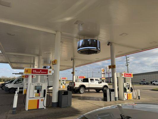 Giant circular monitors above the gas pumps