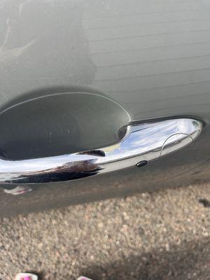 Scuffed chrome handle before replacement