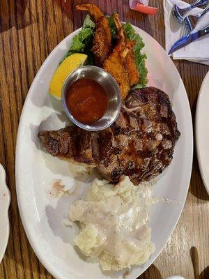 Ribeye steak with shrimp and mashed potatoes