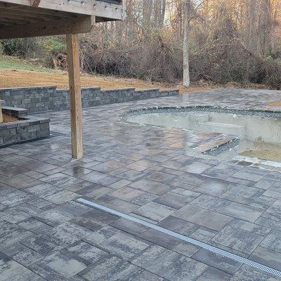 Paver patio and retaining wall around swimming pool
