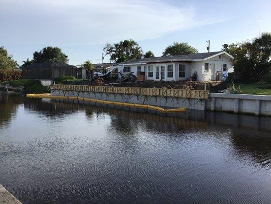 Seawall repair being done on a residential property.