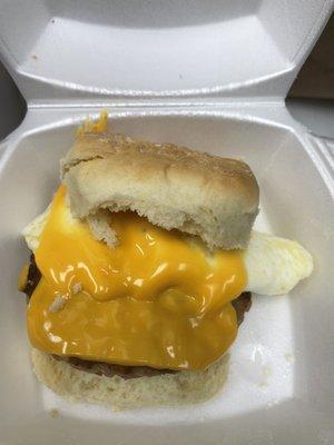 Cheese melting over sausage and biscuit