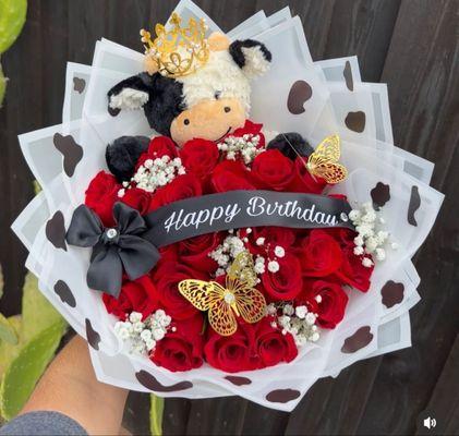 Red roses with baby's breath and stuffed animal with butterflies and to top it off ribbon with diamonds