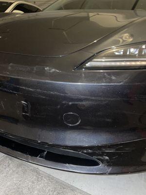 Additional view of the visible damage that requires Tesla-certified OEM repairs.