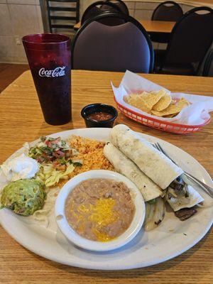 Carne' asada beef tacos with refried beans and rice.