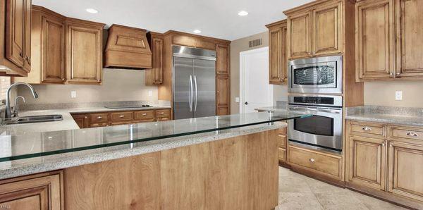 Heavy glass counter top installed in kitchen with chrome.