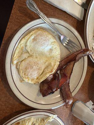 Over easy eggs with bacon