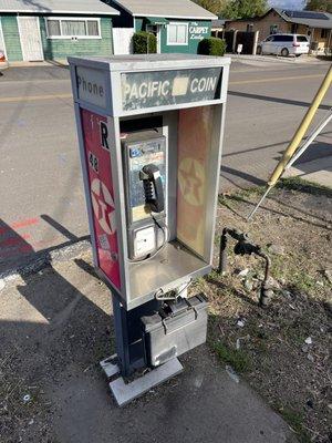 This place has a payphone. Phone book and all. Don't know if it works but sure looks like it.
