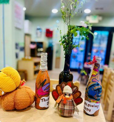 Upcycled glass bottles for Thanksgiving flower or candle holders!