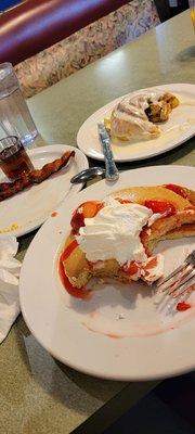 Strawberry pancakes breakfast special combo with 2 bacon, 2 eggs ($10.99) with side of cinnamon roll ($5)!