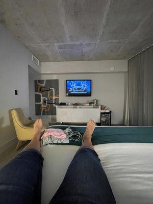 King bed room. Cement ceiling. Located right outside of restaurant entrance.