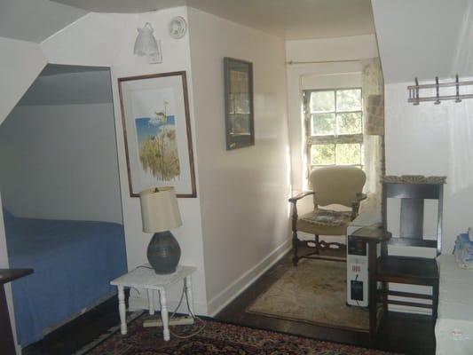 The back room also has a full and a twin bed, The full bed is in an alcove.  The window faces a garden area.