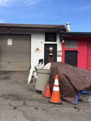 One of the two bay doors. Their Knowledge of Porsche 356 is not demonstrated by the front of the building.