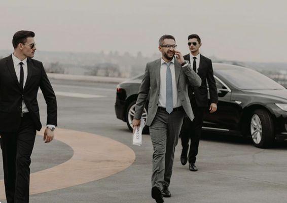 two agents protecting someone