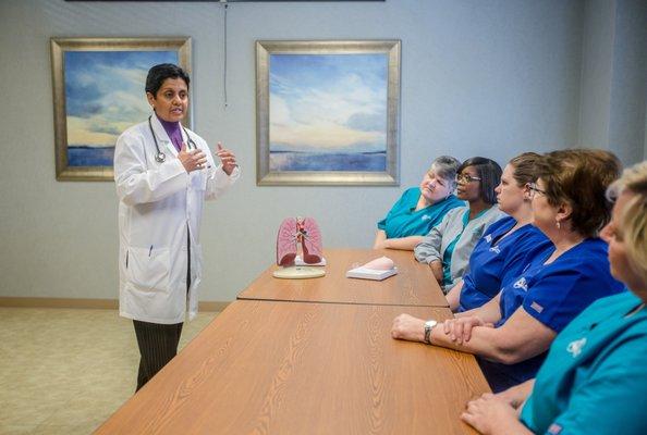Dr. Alice David talks with a team of healthcare professionals at Augusta Oncology.