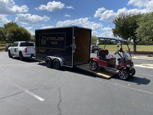 2025 Evolution Classic 2 Plus electric golf cart with Sterling Carts branded delivery trailer