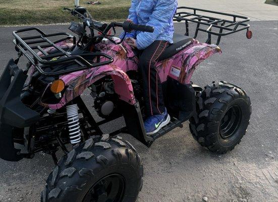 My 6 year old on the bigger kid size 4 wheeler