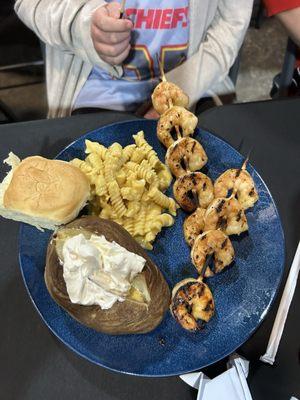 Shrimp skewer dinner with baked potato and macaroni and cheese