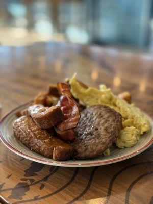 Breakfast plate: French toast, bacon, sausage, eggs, potatoes