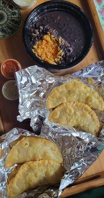 Beef and chicken empanadas and rice with black beans.