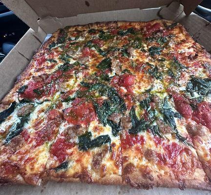 Grandma's pizza with sausage and spinach, light pesto. Well done.