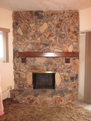 Picture of finished mantle installed in stone fireplace. March 2013.