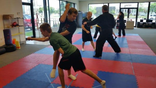 New students practicing with training partners.