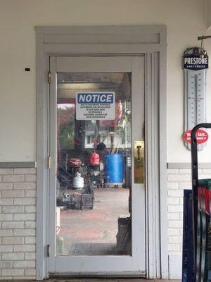 Next to front desk, door into the workspace