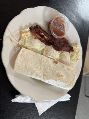 Old Man with thee eggs, bacon, and tortilla.