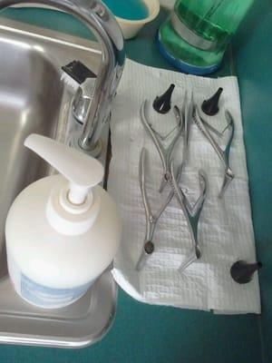 Medical equipment washed in sink. Reused cheap black plastic guard that fits on end of lighted ear/nose scope. Gross!