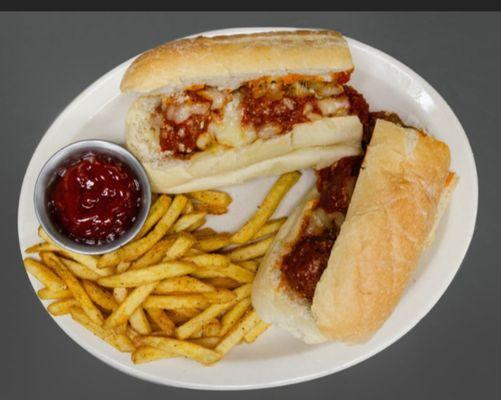 Meatball sandwich with fries.