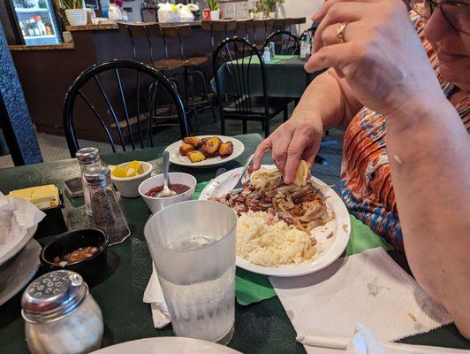 Pork chops and grilled onions with rice and RK beans....extra side of Plantanos Maduro