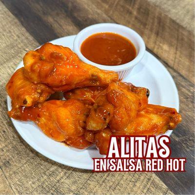 Delicious fried chicken wings sautéed in red hot sauce