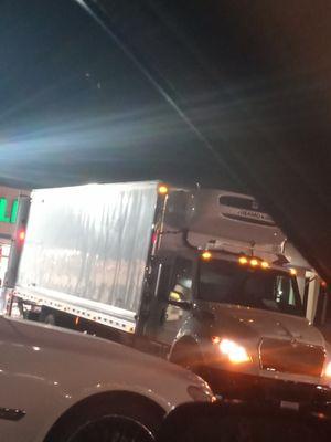 This is the delivery truck in reference to and off to the left of the truck you can see a red little Pole that's where the entrance is at