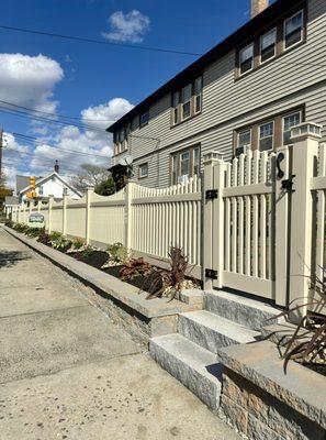 Beige Scalloped Vinyl Fence with GateSolar caps Granite Steps Nicolock Retaining wall and landscaping design by Done Right La...
