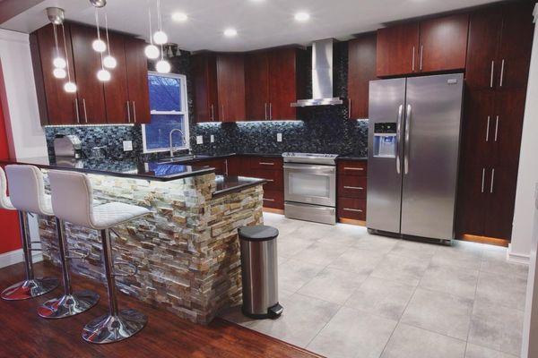 Full kitchen remodel, new tiled floor, new tiled backsplash, new countertops, new dry stacked stone around raised bar face.