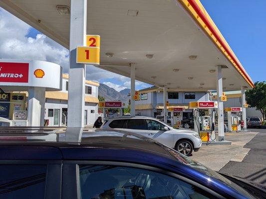 There are 10 pumps at this station. Outside the gas station and convenience store, Aloha Island Mart.