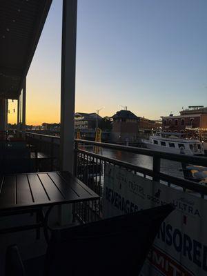 View of the balcony by the river at sunset.