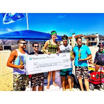 Team Rate My Contractor donating money to habitat for humanity after winning a volleyball tournament